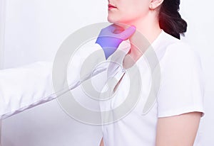 A specialist doctor diagnoses and examines a girl`s sore throat, the presence of inflammation and swelling, pharyngitis and sore photo