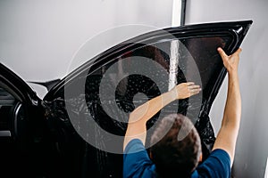 Specialist with drier, tinting film installation photo