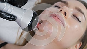 Specialist employs RF technology on face to reverse signs of aging