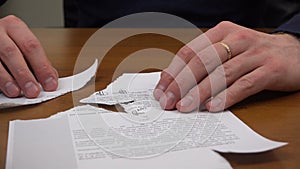 Specialist hands restore a printed document from different scraps