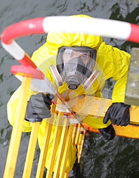 Specialist in protective suit and mask on ladder