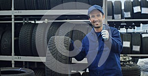 Specialist tire fitting in the car service, checks the tire and rubber tread for safety. Concept: repair of machines,