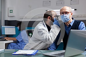 Specialist using otoscope to do ear examination on elder man