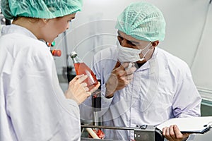 Specialist working team checking product drink bottle contaminate cleaning quality in factory. teamwork high standard people in