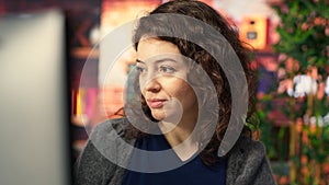 IT specialist at workstation programming on monitor and writing lines of code