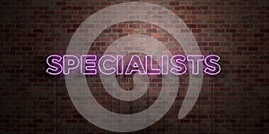 SPECIALISTS - fluorescent Neon tube Sign on brickwork - Front view - 3D rendered royalty free stock picture