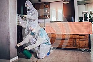 Specialists in protective suits do disinfection or pest control