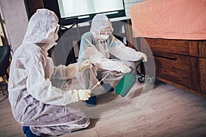 Specialists in protective suits do disinfection or pest control