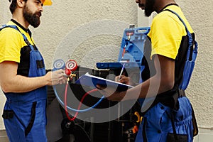 Specialists refilling condenser freon