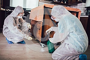 Specialists take samples from surfaces in the home to test for a new corona virus