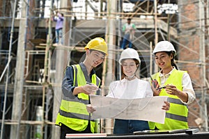 Specialists and team of civil engineer working, checking plan together at construction site