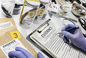 Specialized criminalistic police work in laboratory collecting data and evidence of a murder