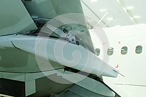 Specialized maintenance of an aircraft wing component in an aerospace workshop during daylight hours with advanced technology