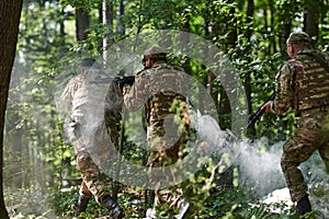 A specialized military antiterrorist unit conducts a covert operation in dense, hazardous woodland, demonstrating photo