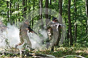 A specialized military antiterrorist unit conducts a covert operation in dense, hazardous woodland, demonstrating photo