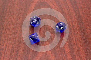 Specialized polyhedral dice for role-playing games on red wooden table