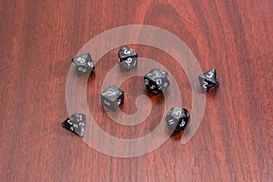 Specialized polyhedral dice for role-playing games on red wooden table