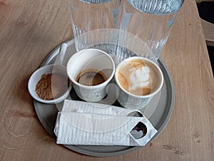 Specialty Coffee Cafe Bar Water and Brown Suggar on Gray Salver