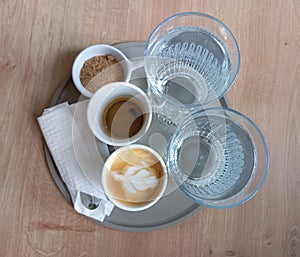 Specialty Coffee Cafe Bar Water and Brown Suggar on Gray Salver