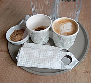 Specialty Coffee Cafe Bar Water and Brown Suggar on Gray Salver