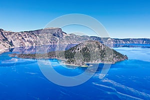 This specifiic Crater Lake blue. Wizard island in the blue water of the Crater Lake