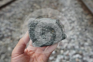 Specimen of Andesite extrusive igneous rock stone a hand.