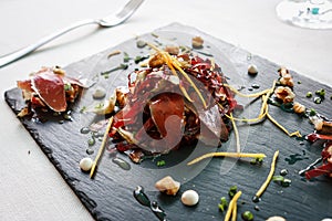 Speck smoked ham appetizer in Cortina D`Ampezzo, Dolomites, It photo