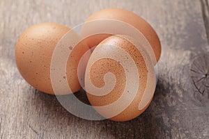 Speckled chicken eggs on old table