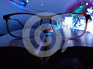 Spectacle Or glasses on book with beautiful background