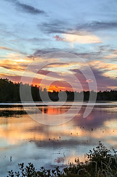 Spectacle Pond near Moosehead Lake, Maine, at sunset with beautiful cloudscape
