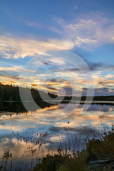 Spectacle Pond near Moosehead Lake, Maine, at sunset with beautiful cloudscape