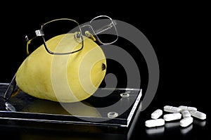 Spectacled pear on a tray and pills