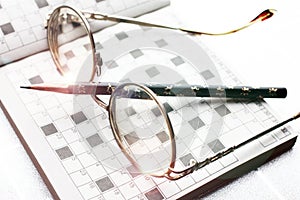 Spectacles, pencil, crossword