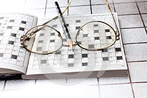 Spectacles, pencil, crossword