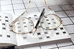 Spectacles, pencil, crossword