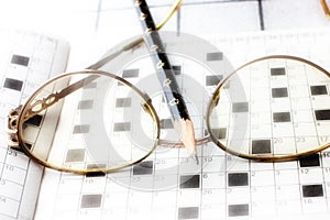Spectacles, pencil, crossword