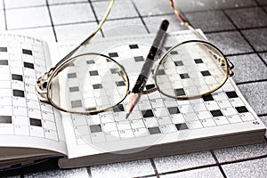 Spectacles, pencil, crossword