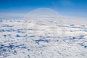 Spectacular aerial view of a huge expanse of sky filled with fluffy white clouds.