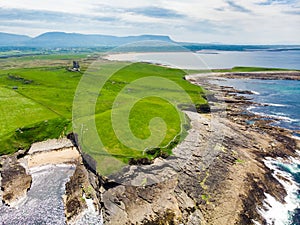 Spectacular aerial view of Mullaghmore Head with huge waves rolling ashore. Picturesque scenery with magnificent Classiebawn