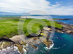 Spectacular aerial view of Mullaghmore Head with huge waves rolling ashore. Picturesque scenery with magnificent Classiebawn Castl