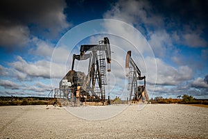 Spectacular aerial view of oil derricks silhouetted against a stunning sky