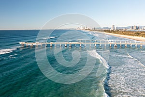 Spectacular aerial view of a surfer taking on waves in a blue ocean