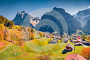 Spectacular autumn view of Grindelwald village valley from cableway with Wetterhorn and Wellhorn peaks on background,