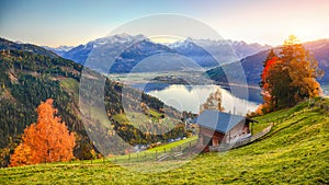 Spectacular autumn view of lake meadows trees and mountains in Sell Am See