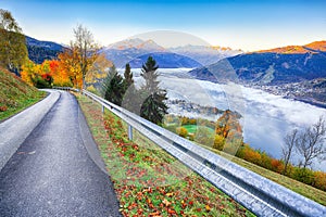 Spectacular autumn view of lake meadows trees and mountains in Sell Am See