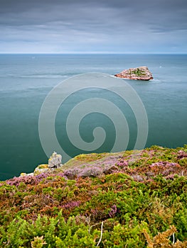 Spectacular cliffs in Cap Frehel, Pointe du Jas and island Amas du Cap on a cloudy day in summer