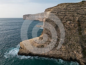 Xlendi cliffs aerial on Gozo island Malta