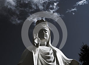 Spectacular cloud over the statue of GuanYin, the Goddess of Mercy and Compassion in the buddhist religion