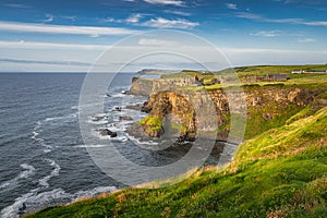 Spectacular coastline, Dunluce Castle located on edge of the cliff, Northern Ireland