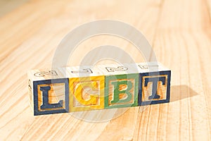 Spectacular colorful wooden cubes with the colors of the LGBTQ gay pride flag with the word LGBTQ